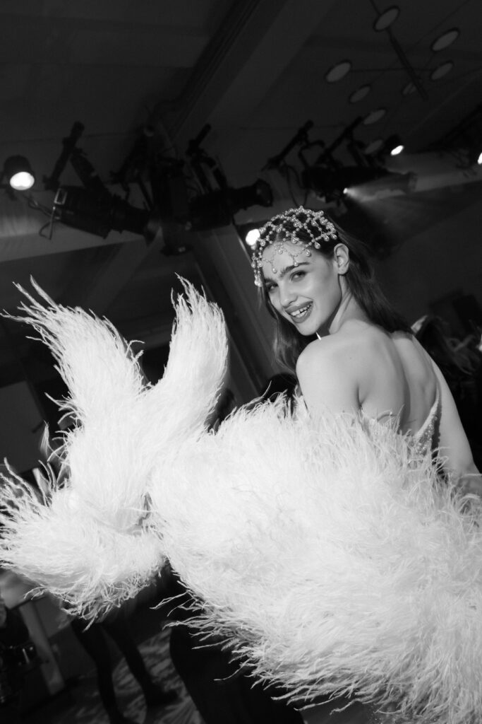 Film photo of Galia Lahav feathered wedding gown on stage at NY Bridal Fashion Week