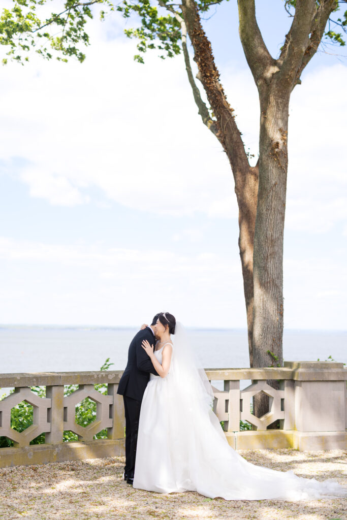 Bride and Groom first look on terrace at Hempstead House wedding venue.