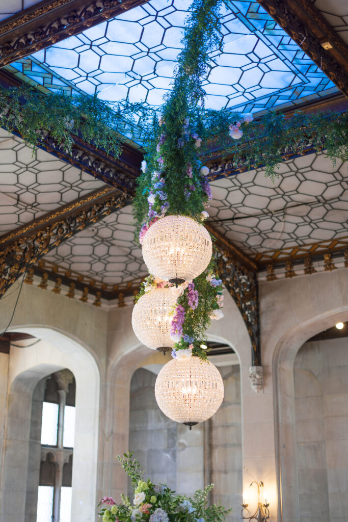 Ballroom with ornate chandeliers at Hempstead House wedding reception.