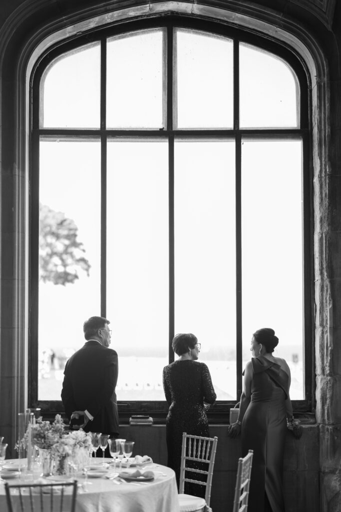 Family members silhouetted by tall windows at Hempstead House.