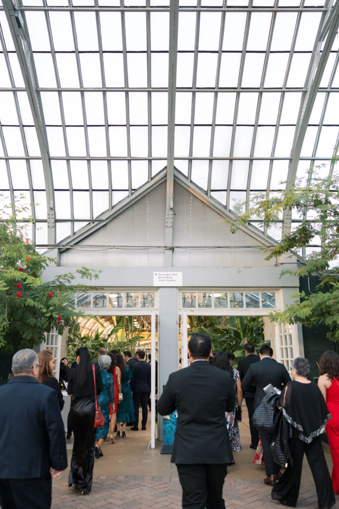 A stunning fall wedding at Garfield Park Conservatory in Chicago. The vibrant autumn foliage serves as a breathtaking backdrop for a couple’s ceremony in the Horticulture Hall, with floor-to-ceiling windows letting in the perfect natural light. Captured by Violet Carter Photography.