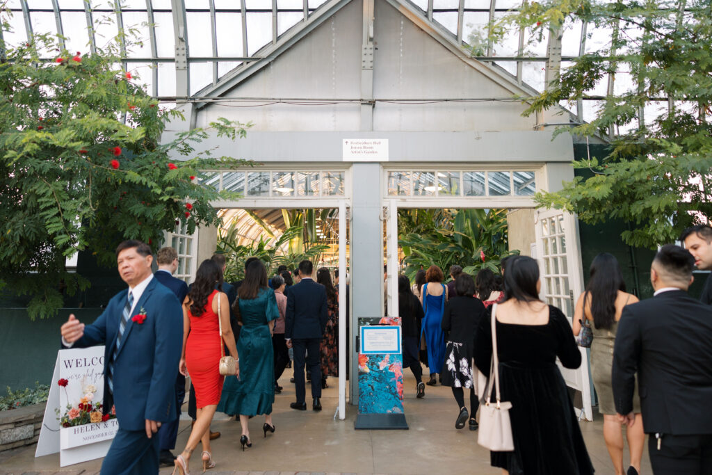 A stunning fall wedding at Garfield Park Conservatory in Chicago. The vibrant autumn foliage serves as a breathtaking backdrop for a couple’s ceremony in the Horticulture Hall, with floor-to-ceiling windows letting in the perfect natural light. Captured by Violet Carter Photography.