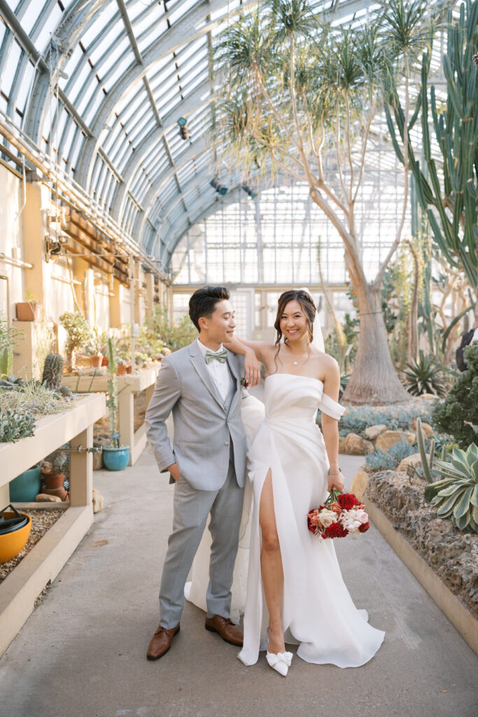 A stunning fall wedding at Garfield Park Conservatory in Chicago. The vibrant autumn foliage serves as a breathtaking backdrop for a couple’s ceremony in the Horticulture Hall, with floor-to-ceiling windows letting in the perfect natural light. Captured by Violet Carter Photography.