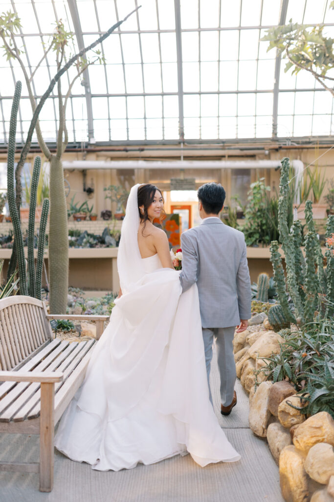 A stunning fall wedding at Garfield Park Conservatory in Chicago. The vibrant autumn foliage serves as a breathtaking backdrop for a couple’s ceremony in the Horticulture Hall, with floor-to-ceiling windows letting in the perfect natural light. Captured by Violet Carter Photography.