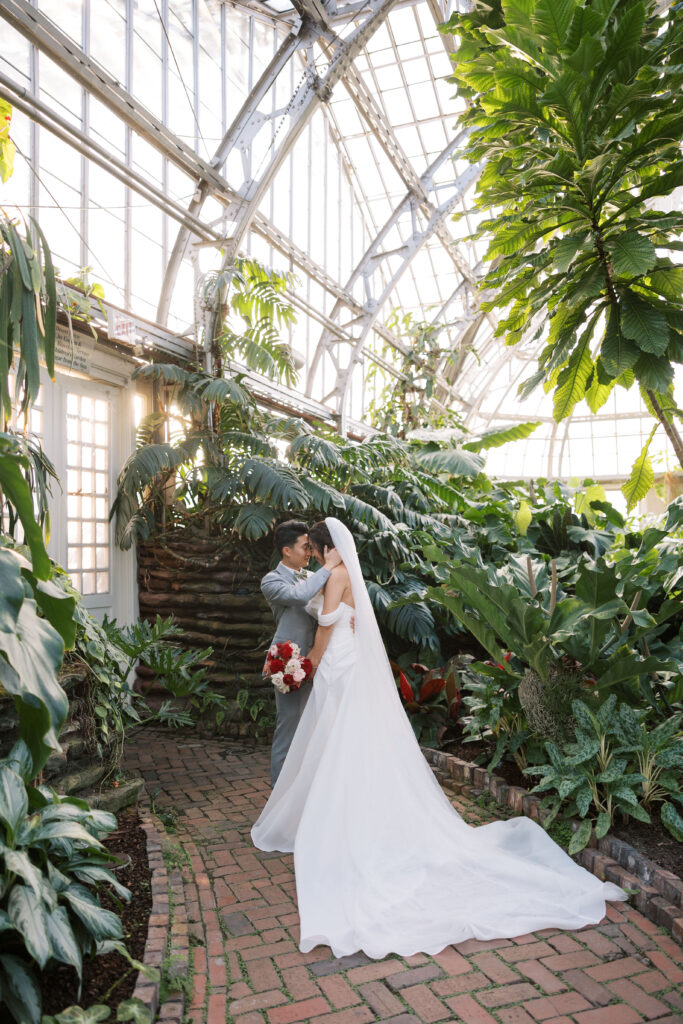 A stunning fall wedding at Garfield Park Conservatory in Chicago. The vibrant autumn foliage serves as a breathtaking backdrop for a couple’s ceremony in the Horticulture Hall, with floor-to-ceiling windows letting in the perfect natural light. Captured by Violet Carter Photography.