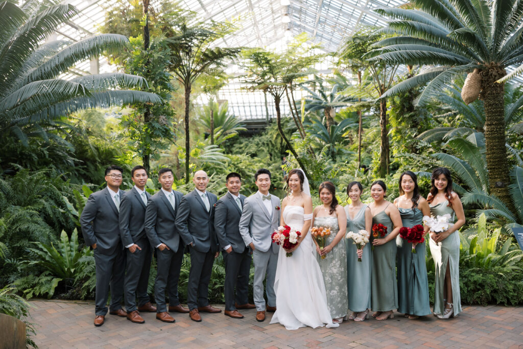 A stunning fall wedding at Garfield Park Conservatory in Chicago. The vibrant autumn foliage serves as a breathtaking backdrop for a couple’s ceremony in the Horticulture Hall, with floor-to-ceiling windows letting in the perfect natural light. Captured by Violet Carter Photography.