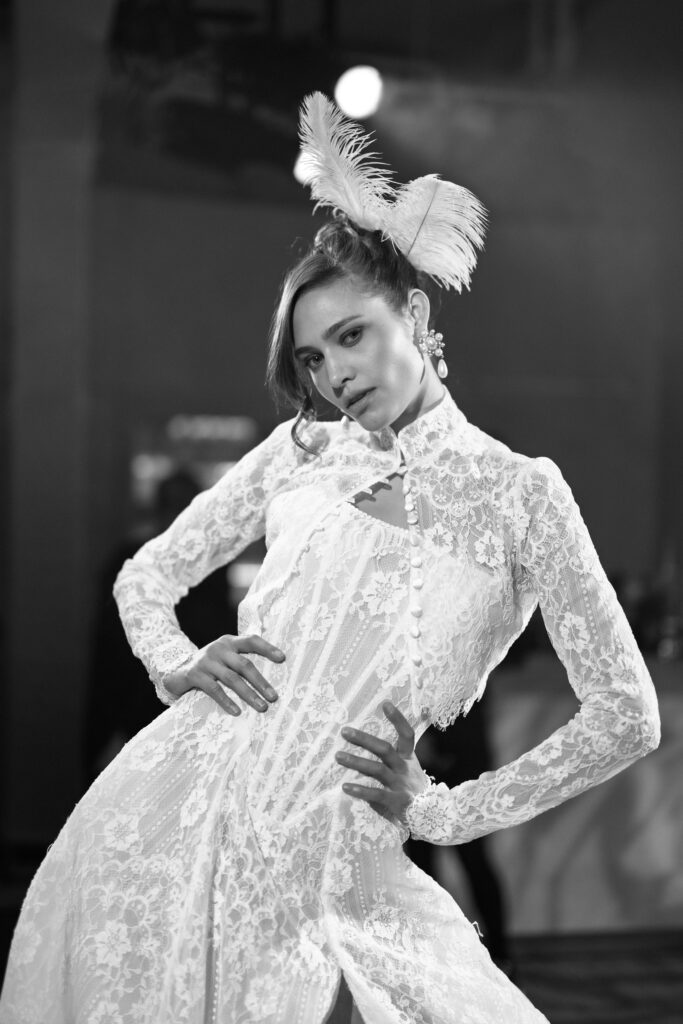 Film photo of Galia Lahav feathered wedding gown backstage at NY Bridal Fashion Week