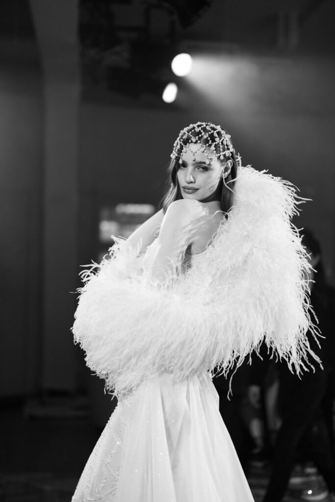 Film photo of Galia Lahav feathered wedding gown backstage at NY Bridal Fashion Week
