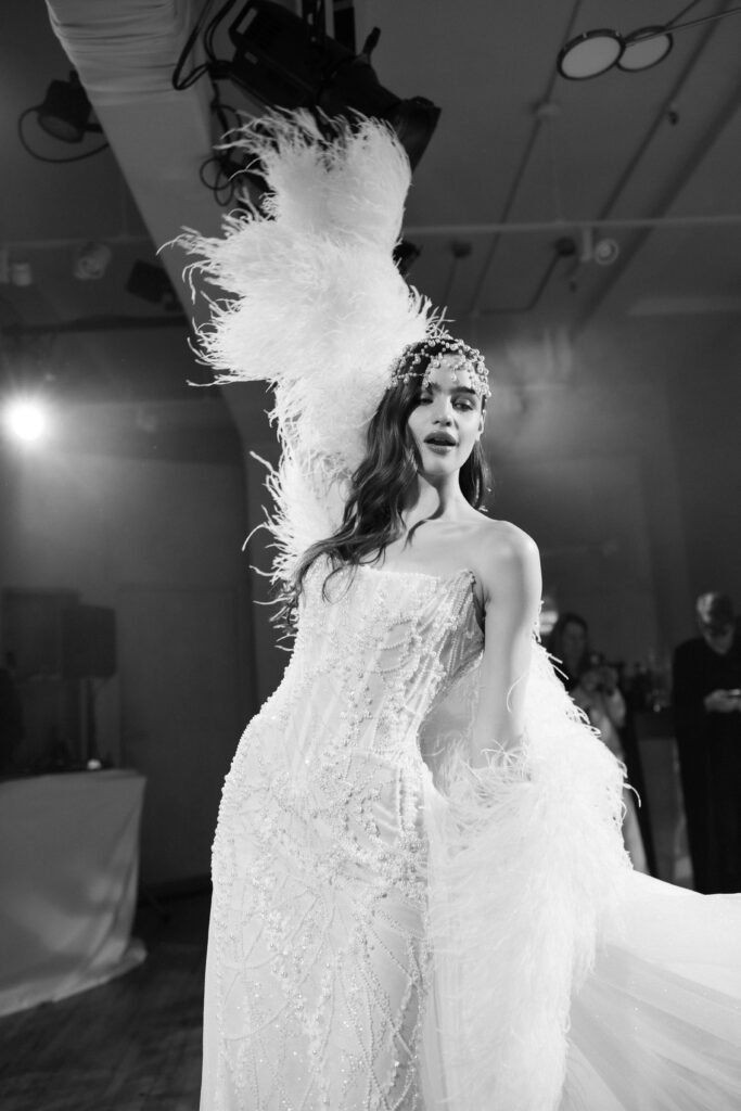  Film photo of Galia Lahav feathered wedding gown on stage at NY Bridal Fashion Week