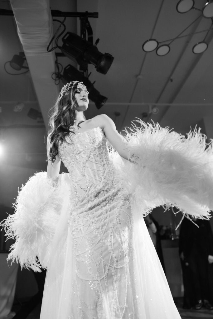  Film photo of Galia Lahav feathered wedding gown on stage at NY Bridal Fashion Week